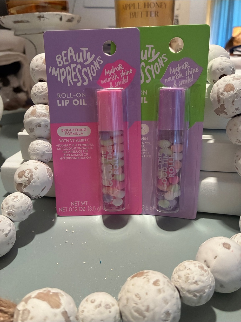Impressions Roll-On Lip Oil Duo in Pink and Purple Packaging
